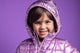 Child in a purple rain jacket