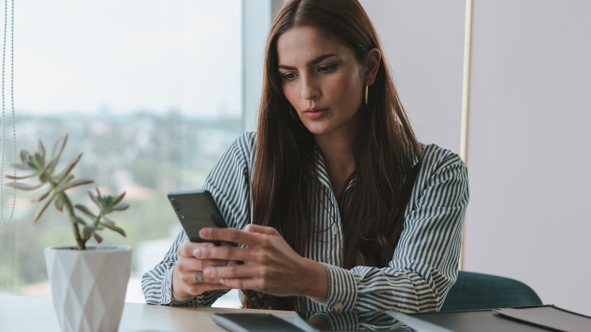 Woman looking at her smartphone while seated