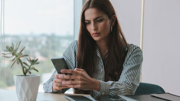 Woman looking at her smartphone while seated