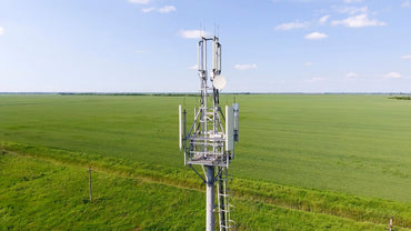 Cellular antenna standing in an open field