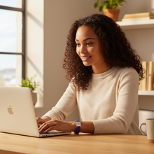 Young woman wearing purple EMF protection bracelet BodyBand Plus on MacBook