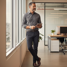 Business man wearing white EMF protection bracelet BodyBand Plus using tablet