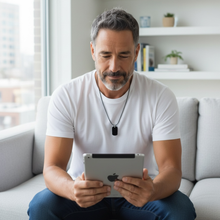 Man wearing EMF protection necklace dog tag BodyShield perfectly imperfect using iPad