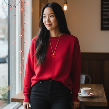 Young woman wearing EMF protection necklace red Valentine heart pendant coffee shop