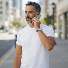man wearing EMF protection bracelet BodyBand Plus black while using cell phone