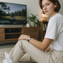 Woman wearing EMF protection bracelet BodyBand Plus black watching TV