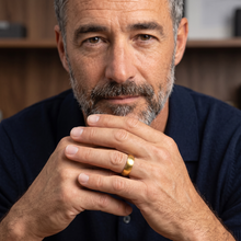 Mature man wearing the Safe Connect Plus gold EMF Protection Ring in a lifestyle setting.