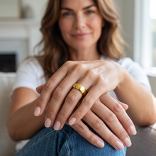 Close-up of a woman wearing the Safe Connect Plus gold EMF Ring with a modern minimalist design.