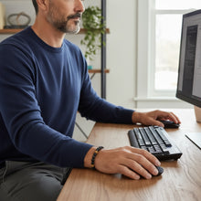 Men’s EMF protection beaded bracelet worn while working at a computer desk