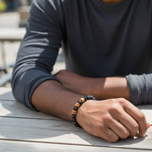 Men wearing black EMF protection beaded bracelet during everyday outdoor activity