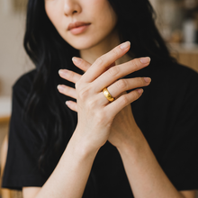 Woman wearing the Safe Connect Plus premium gold EMF Protection Ring as part of an everyday jewelry collection.