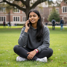 College student wearing pink EMF protection bracelet BodyBand Plus on phone call