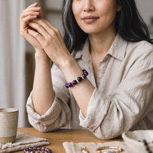 Woman wearing the Amethyst EMF Protection Beaded Bracelet indoors