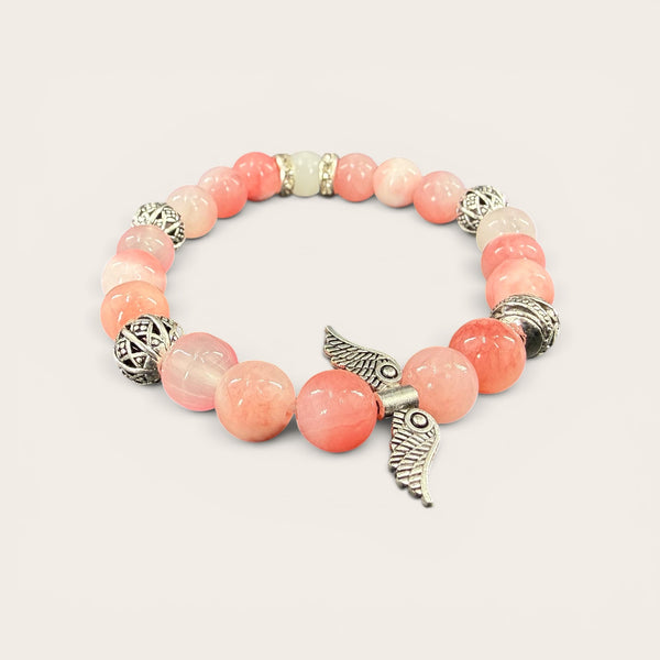 Angel Wings EMF Protection Bracelet in Blush Pink featuring pink beaded jewelry with decorative angel wing charm