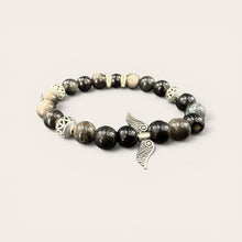 Angel Wings EMF Protection Bracelet in Midnight Black featuring black and gray beaded jewelry with decorative angel wing charm