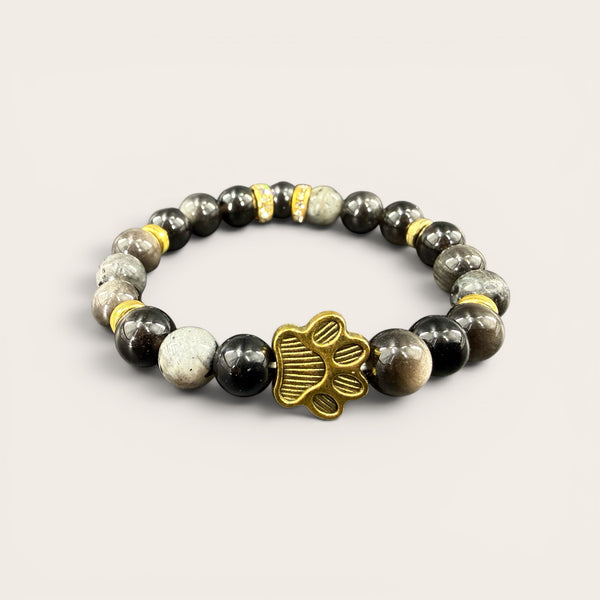 Black EMF protection bracelet with gold dog paw charm featuring 240+ resonant frequencies for everyday wellness and pet lovers