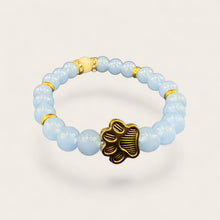 Blue EMF protection bracelet with gold dog paw charm featuring 240+ resonant frequencies for everyday wellness and pet lovers.