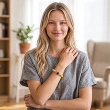 Woman wearing the Citrine EMF Protection Beaded Bracelet indoors in a grey top