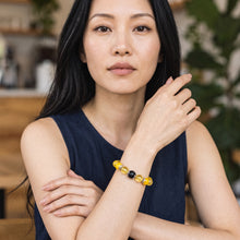 Woman wearing the Citrine EMF Protection Beaded Bracelet in a navy top