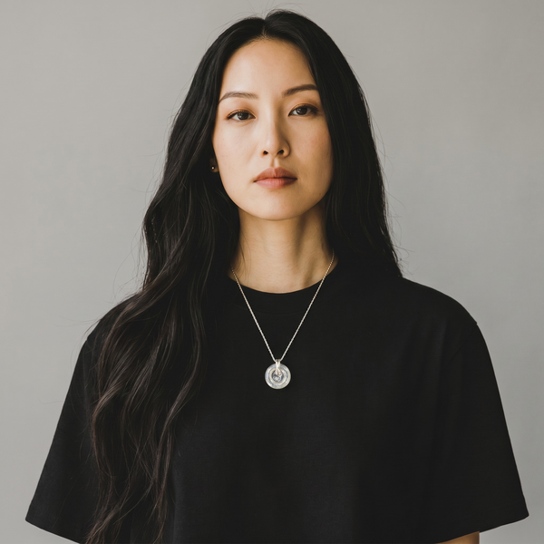 Woman wearing a Clear EMF Protection Button Necklace with stainless steel chain for everyday wearable protection and wellness.