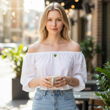 Woman wearing emerald heart EMF protection necklace for daily energetic balance