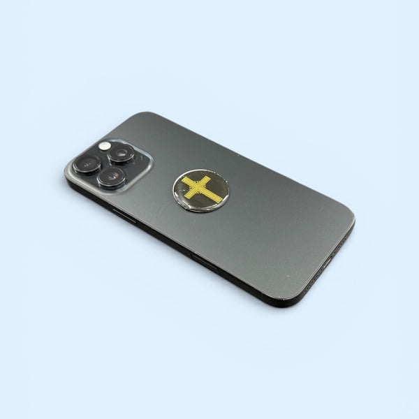 Gold Cross EMF Protection Mega Shield applied to smartphone for device EMF protection