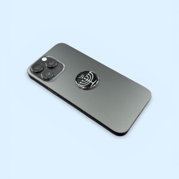 Silver Menorah EMF Protection Mega Shield applied to smartphone for device protection