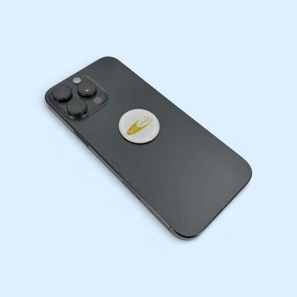 EMF Protection Mega Shield White and Gold attached to smartphone for device EMF protection