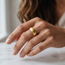 Close-up of the Safe Connect Plus Gold EMF Protection Ring worn on the middle finger, highlighting its brushed gold finish and comfortable everyday fit.