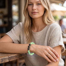 Woman wearing the Green Aventurine EMF Protection Beaded Bracelet at a café table
