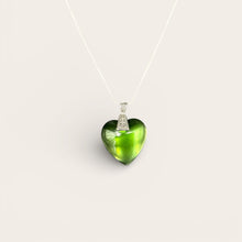 Large emerald heart EMF protection necklace with silver chain and ornate bezel on white background