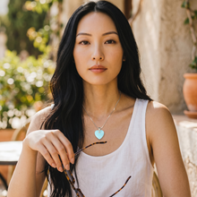Woman wearing a Neon Blue Heart EMF Protection Necklace, a lightweight heart-shaped pendant designed for everyday wear.