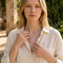 Woman wearing a Neon Pink Heart EMF Protection Necklace with stainless steel chain and sparkling heart pendant.