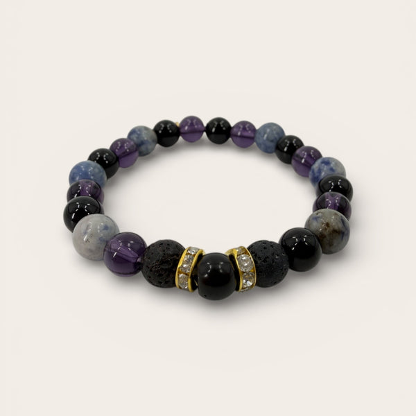 Nightfall EMF Protection Beaded Bracelet with black lava stone, purple gemstone beads, and gold crystal spacers on a white background