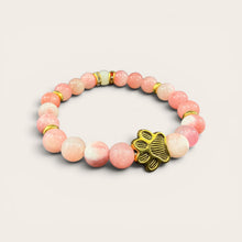 Pink EMF protection bracelet with gold dog paw charm infused with 240+ resonant frequencies for everyday wellness and EMF protection.