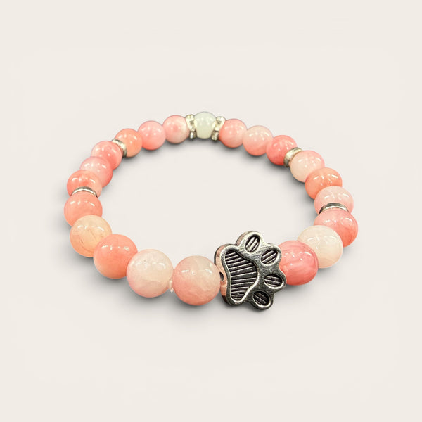 Pink EMF protection bracelet with silver dog paw charm featuring 240+ resonant frequencies for everyday EMF protection.