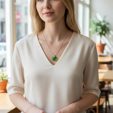 Small and large emerald heart EMF protection pendant size comparison