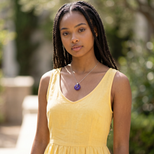 Young woman wearing a Purple EMF Protection Button Necklace as fashionable wearable EMF protection for everyday wellness and modern lifestyles.